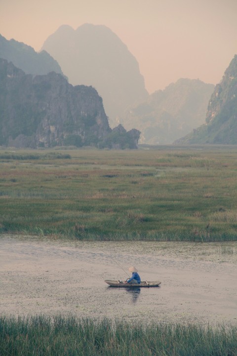 person riding on boat on green grass field during daytime lB561L