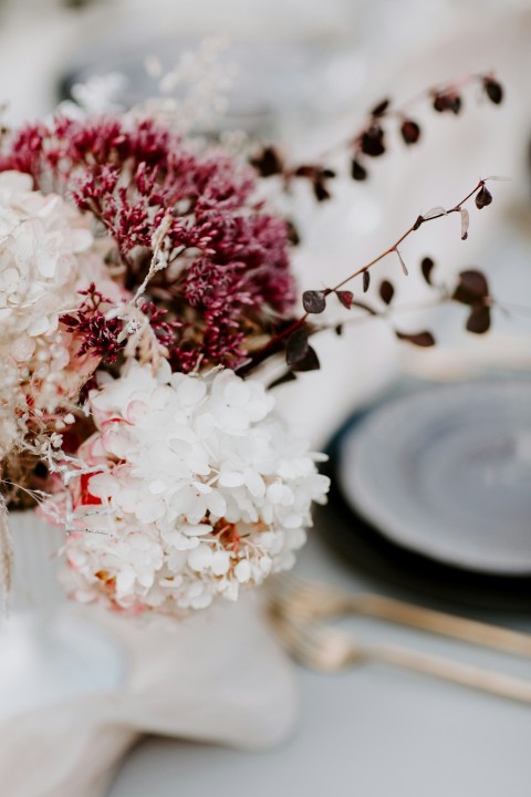 a bouquet of flowers sitting on top of a table oA