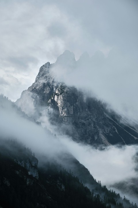 a mountain with clouds around it