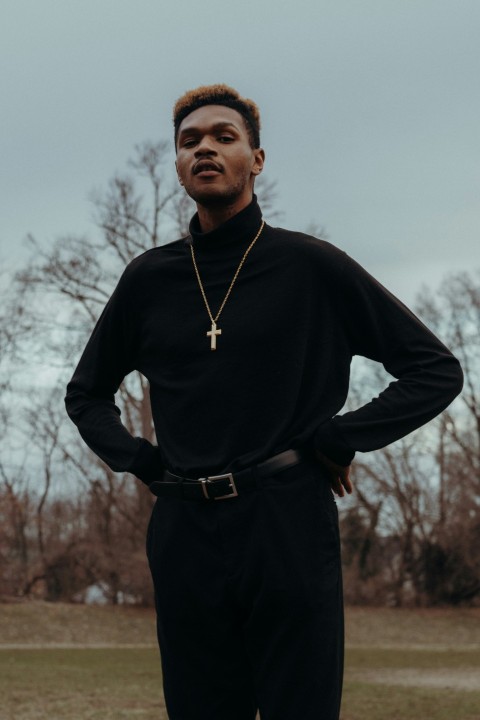 man in black long sleeve shirt standing near bare trees during daytime