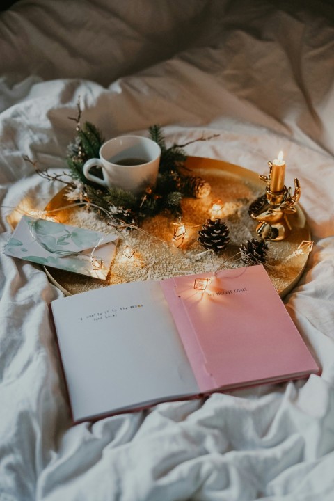 white ceramic teacup on serving tray and book SWpRx