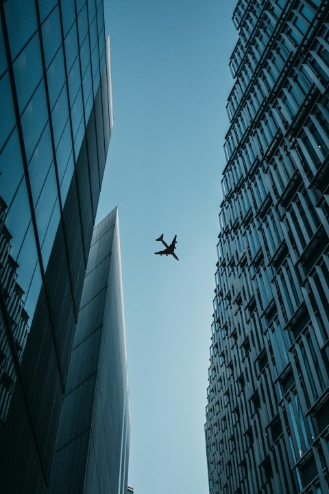 flying airplane above high rise airplanes FMwrQjB0q