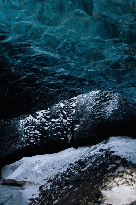 a large ice cave filled with water and snow