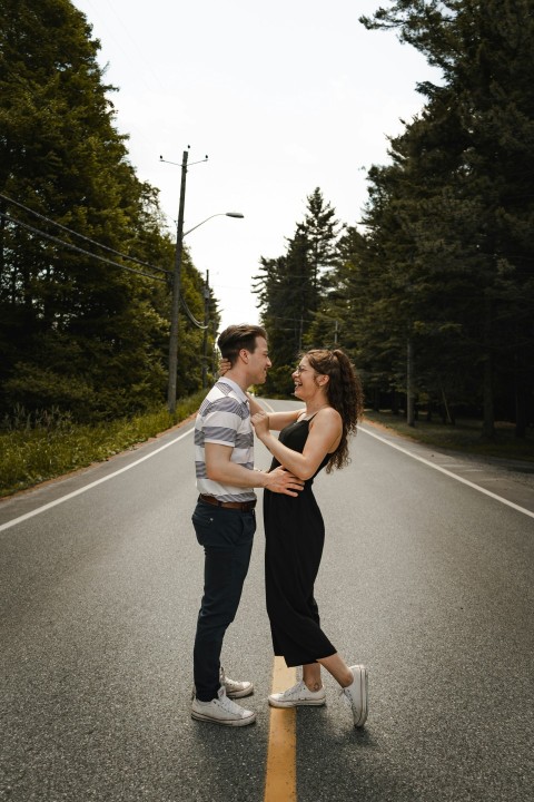 man and woman kissing on road during daytime