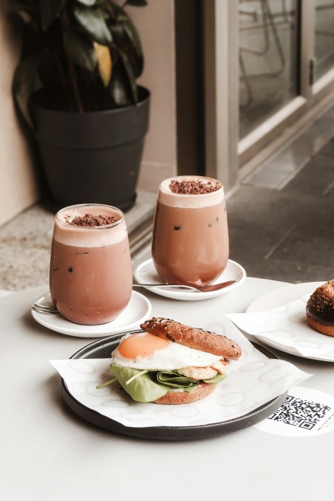 two brown ceramic jars on white ceramic plate