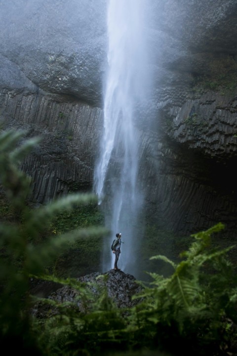 person standing near waterfalls TtBl7Hv