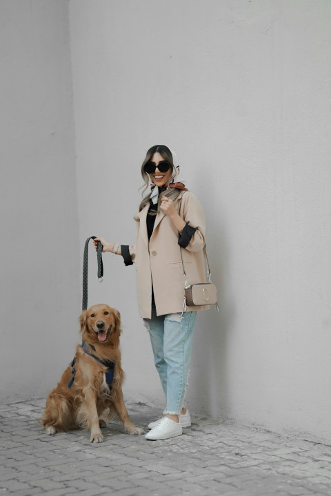 a person standing next to a dog