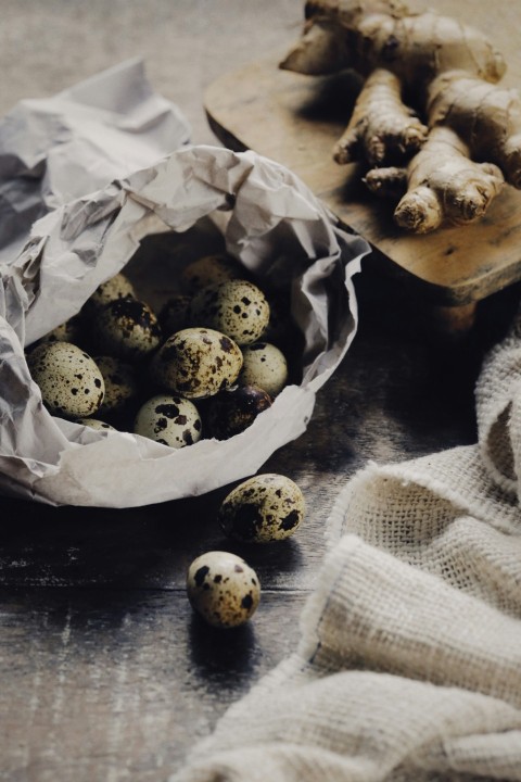 a bag of quails sitting on a table next to a wooden spoon