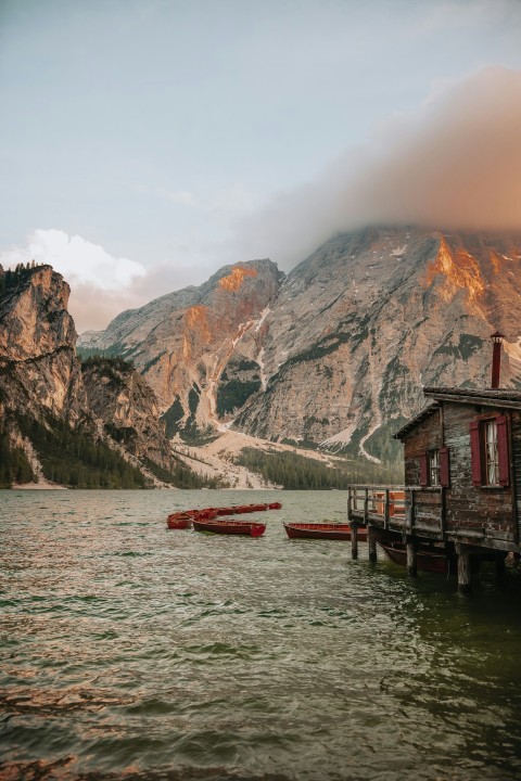 red boat on water near brown mountain during daytime