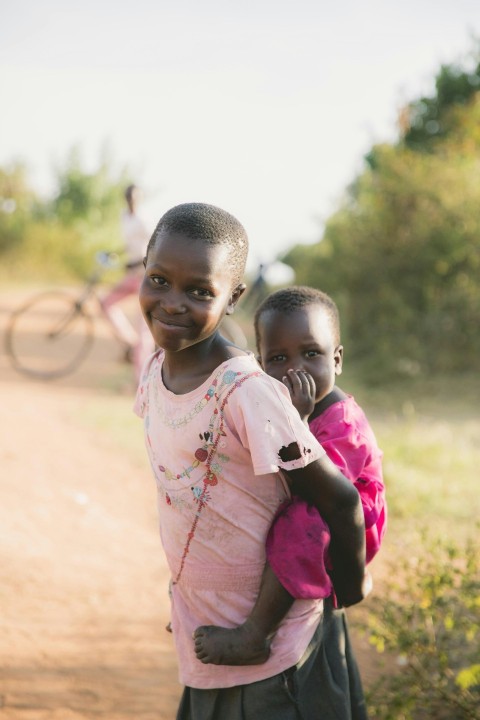 girl carrying boy on her back