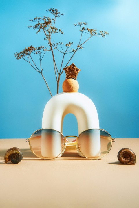 a pair of sunglasses sitting on top of a white object