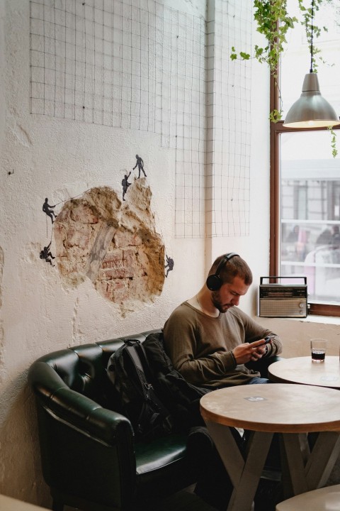 a man sitting at a table using a cell phone