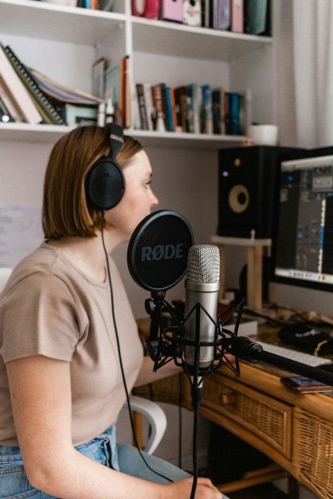 woman in white shirt standing in front of microphone