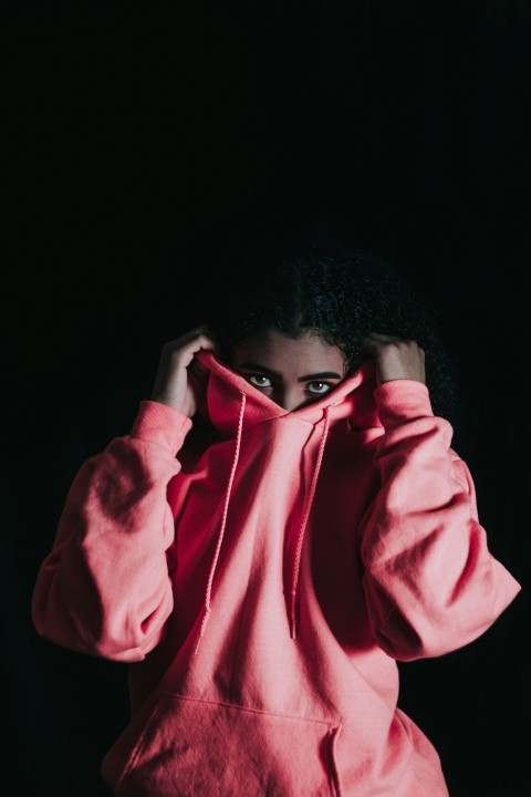 girl wearing pink pullover hoodie covering her nose wmUHw