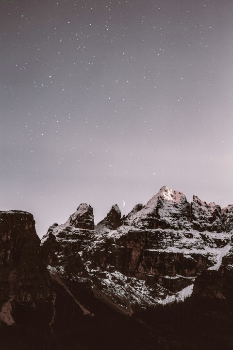 mountain range covered by snow during nighttime