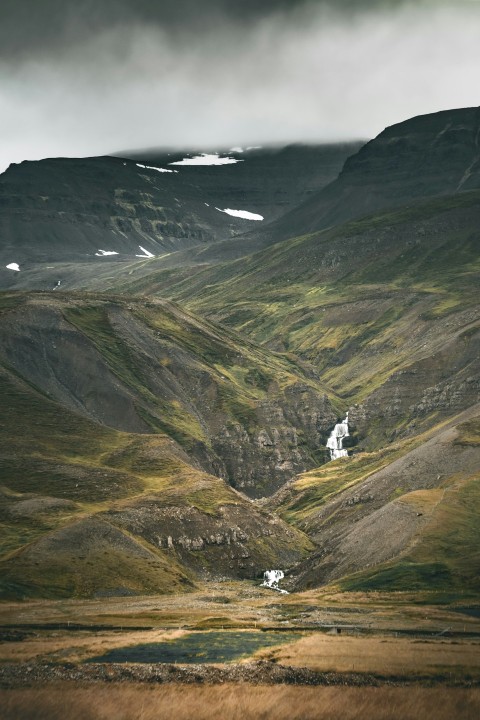 a mountain range with a house in the middle of it