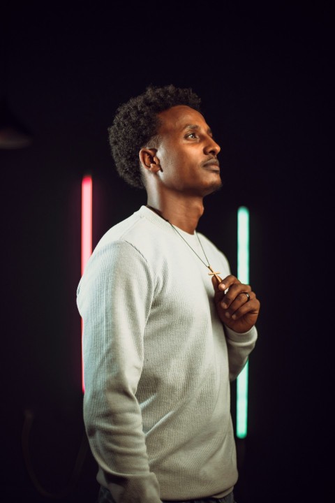 a man standing in front of a black background