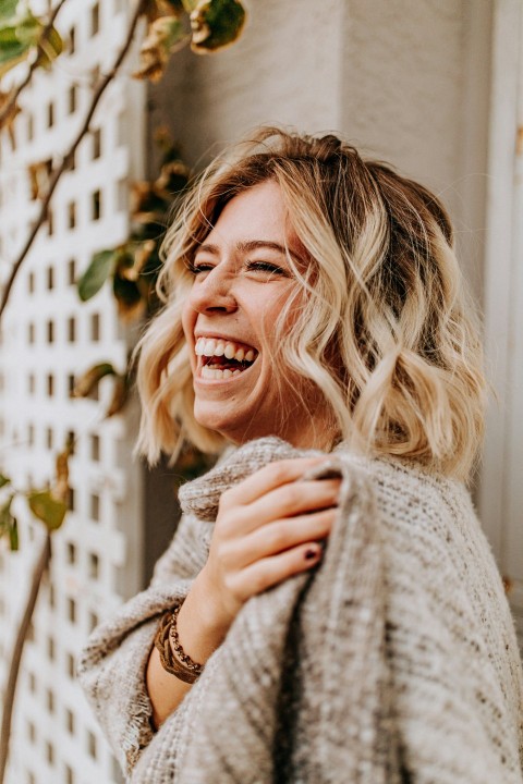 woman smiling near building