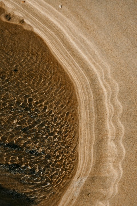 brown sand with water during daytime c