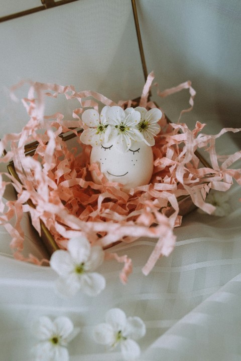 pink and white flower on white ceramic bowl