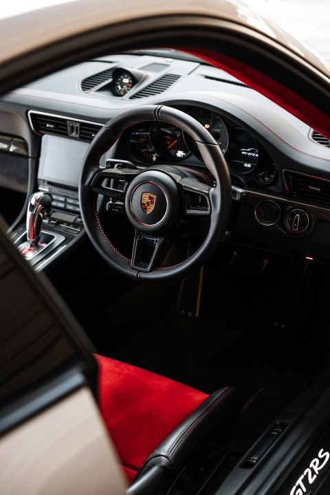 the interior of a sports car with a red carpet