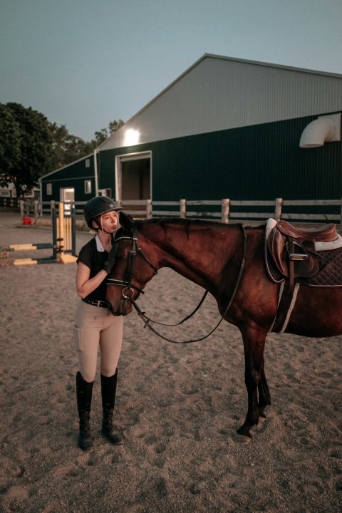 a person standing next to a horse