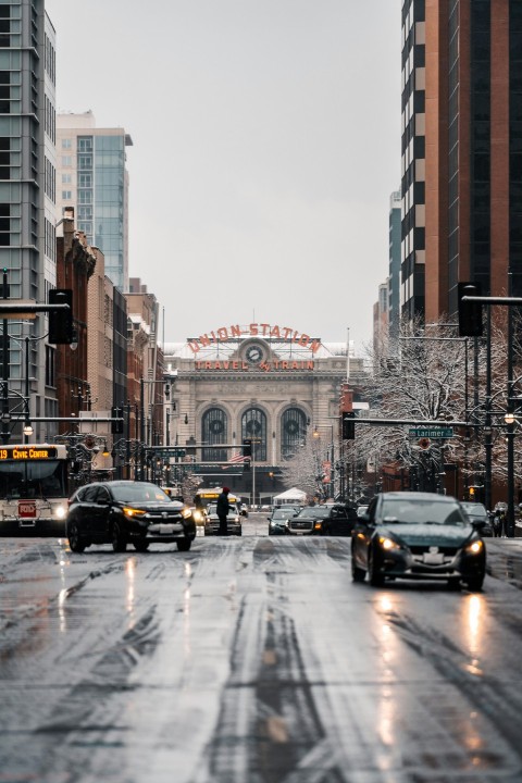 a city street filled with lots of traffic next to tall buildings