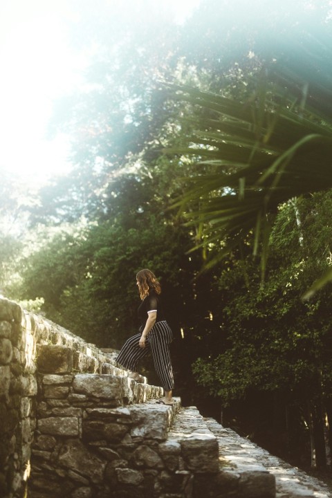 woman walking on stair during daytime u4r19