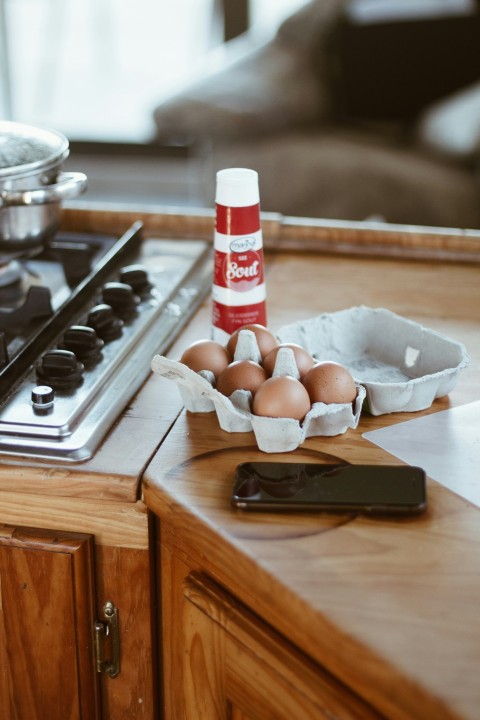 white and red plastic bottle on brown wooden chopping board