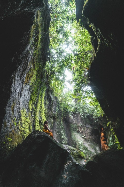 woman sitting on the stone near the tunnel