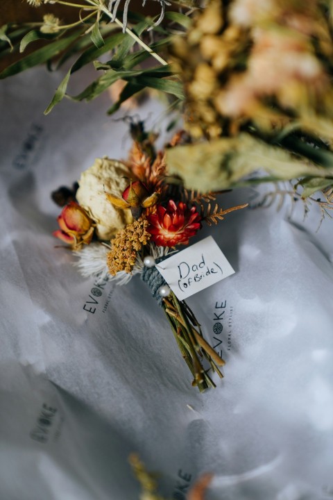 white and red flower bouquet on white paper