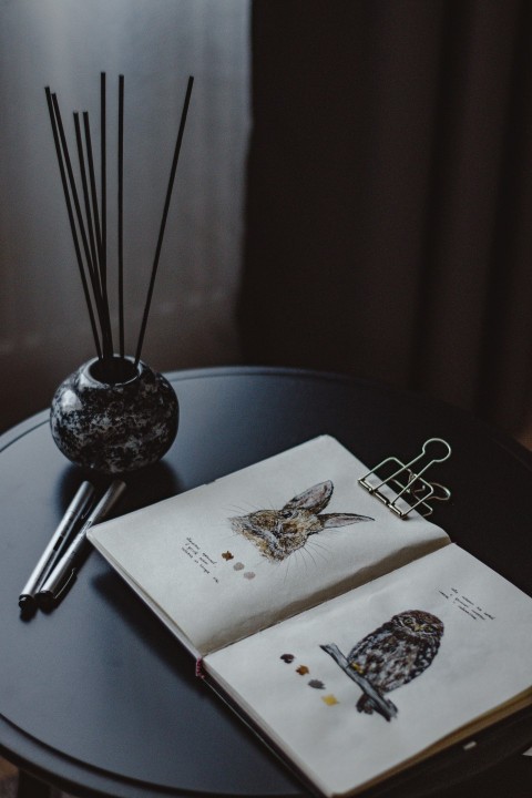 a table with a plate and a glass bowl with a plant on it