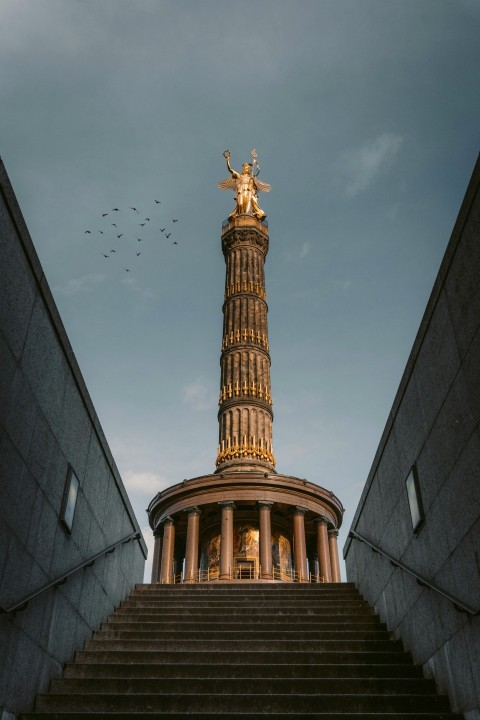 brown concrete tower under white clouds during daytime