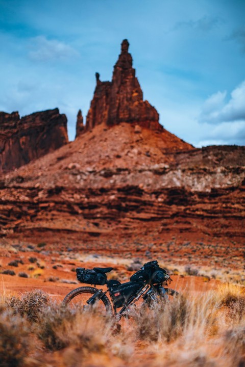 black mountain bike parked on brown field during daytime