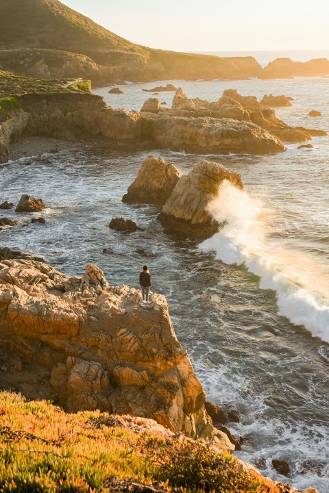 a person standing on a rock in the water htS4