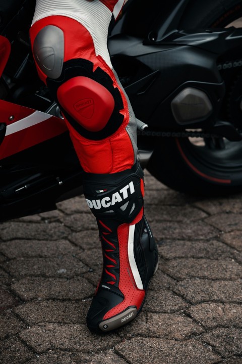 a close up of a person wearing red and white shoes