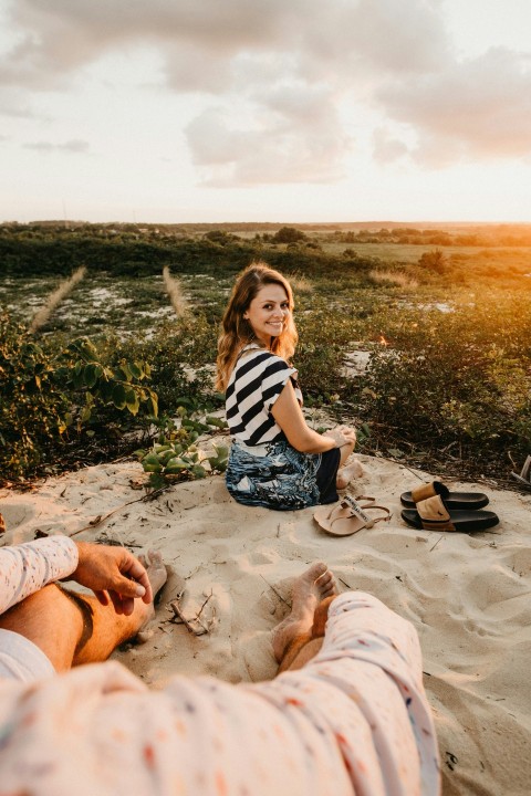 woman sitting on gray sand