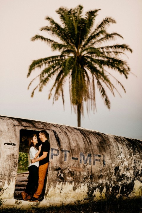 man in white t shirt and black shorts standing beside wall