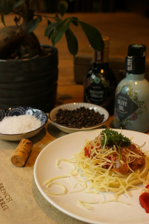 a white plate topped with spaghetti and sauce