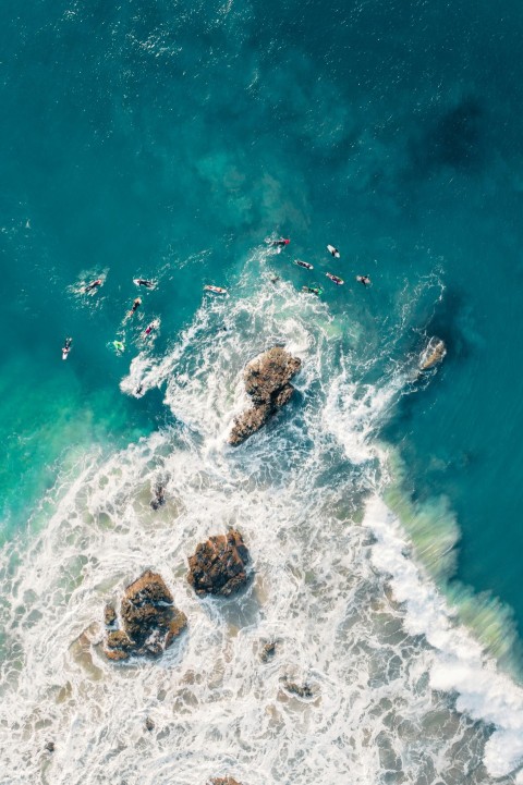 brown rock formation on body of water during daytime