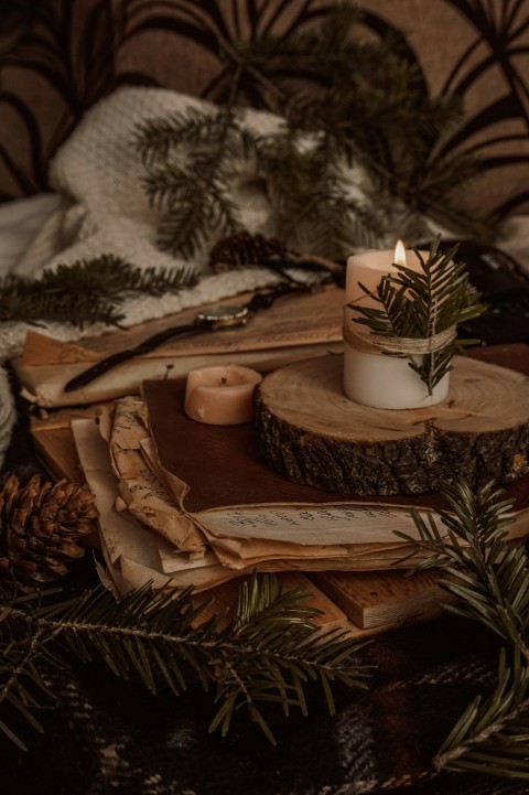 white pillar candle on brown wooden tray