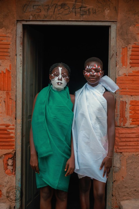 two women with painted faces standing in a doorway 0Rs7LP6x3