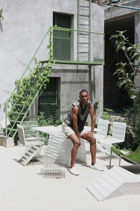 a man sitting on a chair outside