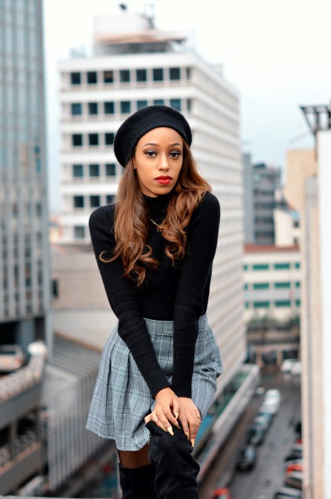 woman in black long sleeve shirt and gray skirt