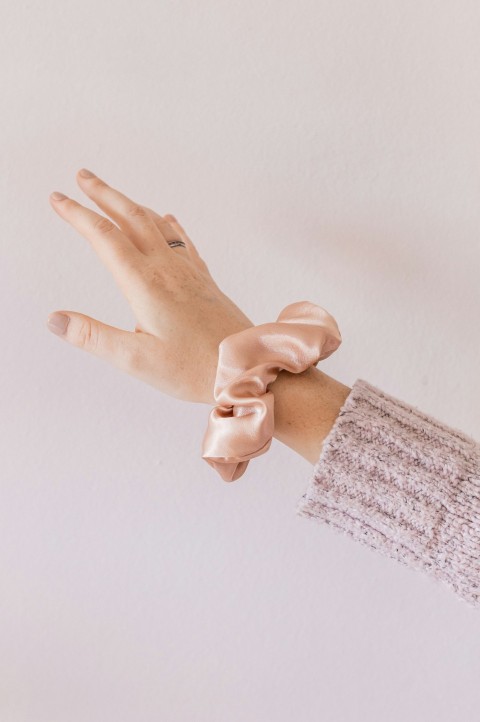 person holding hands with pink manicure