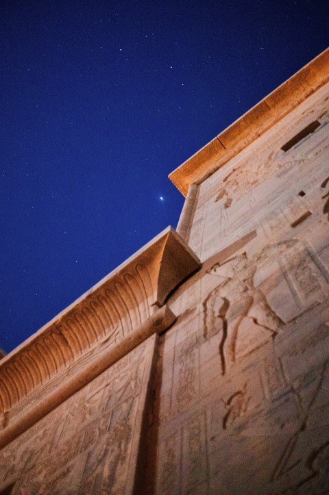 a tall building with carvings on the side of it