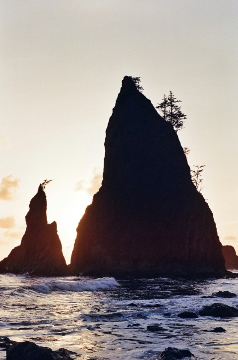 a couple of large rocks sitting in the middle of the ocean hzfDBCp5d