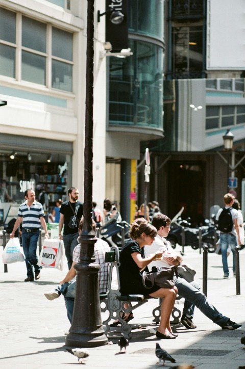 man and woman sitting on bench