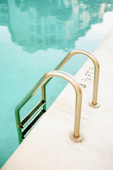 white metal railings near body of water during daytime DHdk4g