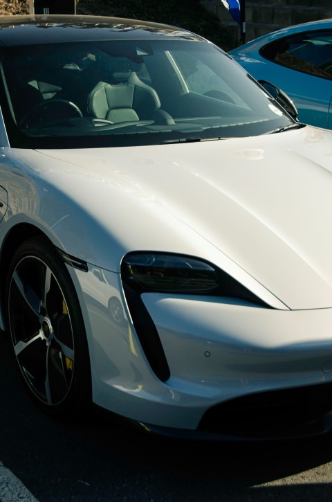 a white sports car parked in a parking lot